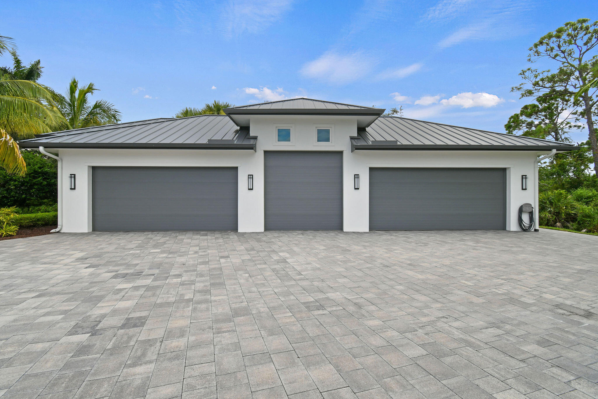 6219 Southeast Moss Ridge Pointe Hobe Sound, FL 33455 - Photo 89 of 108 a front view of a house with a yard and garage