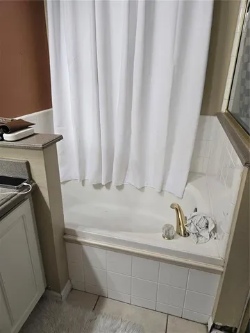 a bathroom with a bathtub and shower