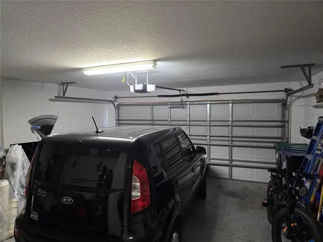 a view of a backyard with table and chairs potted plants and a wooden floor