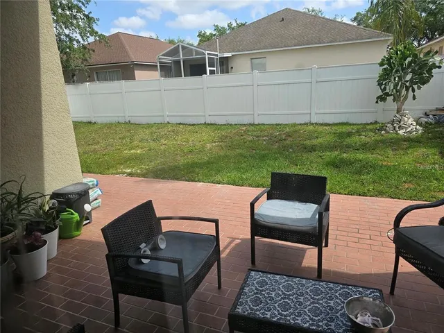 a view of a house with backyard and porch