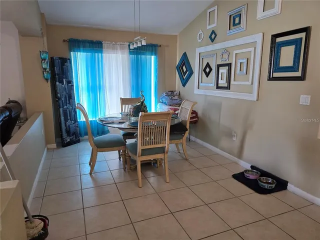 a dining room with furniture and window