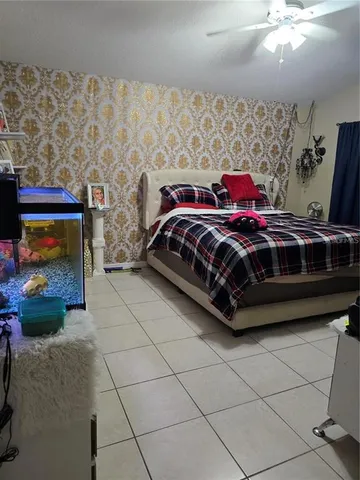 a bedroom with a bed and a fireplace