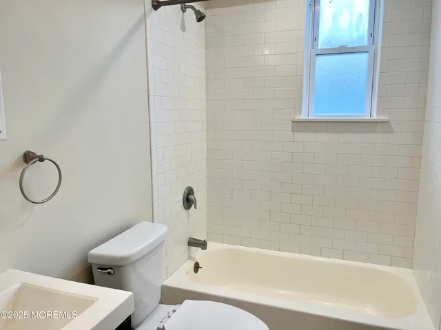 a bathroom with a toilet a sink and bathtub