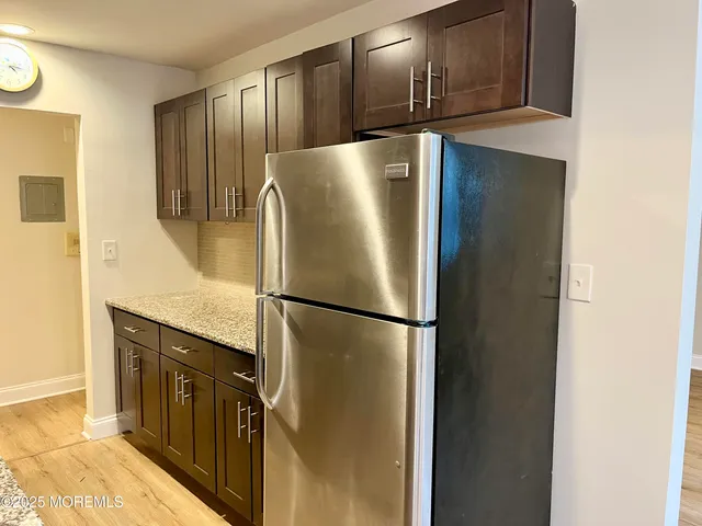 a kitchen with stainless steel appliances granite countertop a refrigerator and a stove top oven