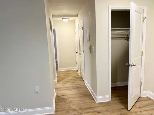 a view of a hallway with wooden floor