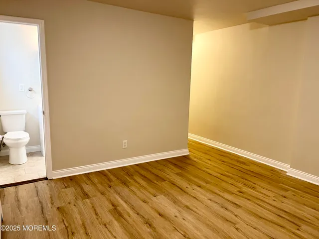 a view of wooden floor and brick wall