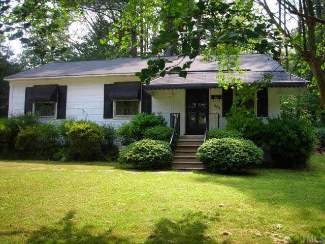 604 Chatham Lane Raleigh, NC 27610 - Photo 1 of 6 a front view of a house with a garden