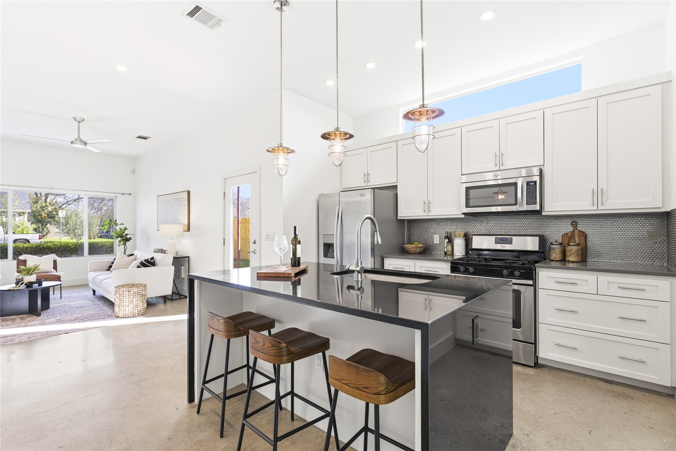 701 Zennia Street, Unit B Austin, TX 78751 - Photo 13 of 40 Kitchen featuring tasteful backsplash, stainless steel appliances, decorative light fixtures, white cabinetry, and recessed lighting