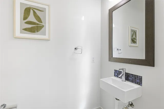 a bathroom with a sink mirror and vanity