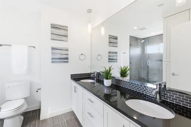 a bathroom with a sink double vanity and a mirror