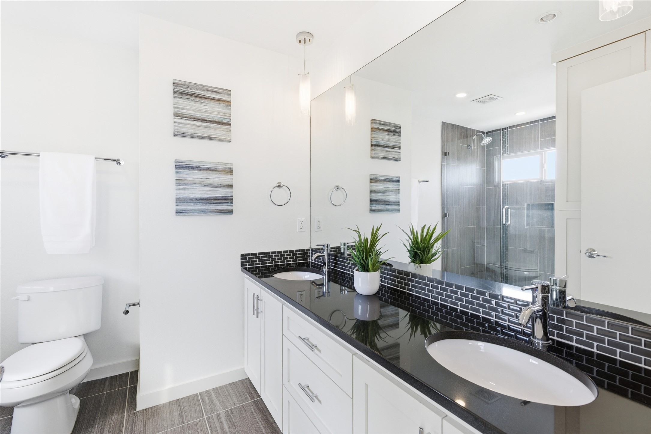 701 Zennia Street, Unit B Austin, TX 78751 - Photo 20 of 40 Bathroom with a stall shower, double vanity, and tasteful backsplash