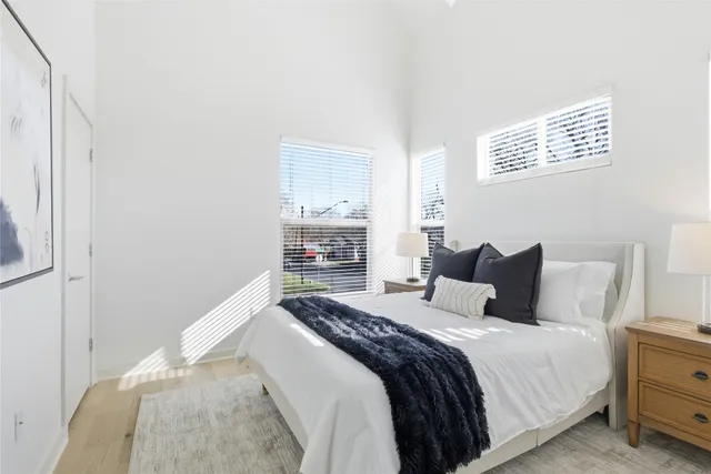 a bedroom with a bed and a window