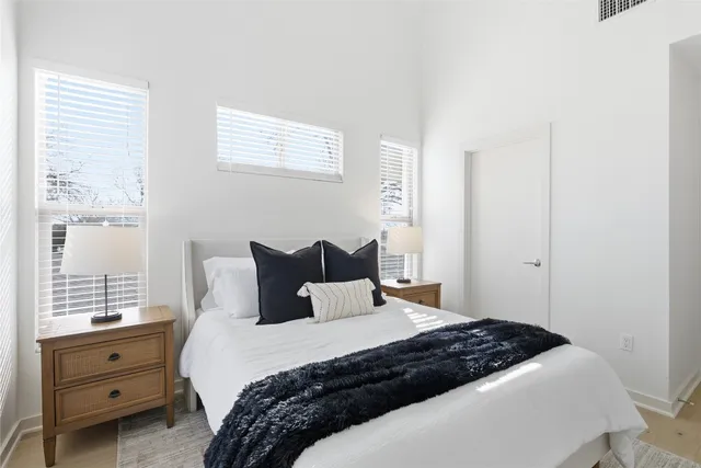 a bedroom with a bed and a window