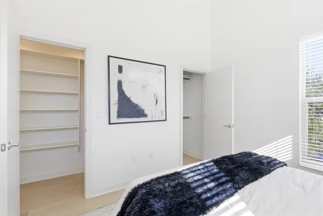 a bedroom with a bed and a window