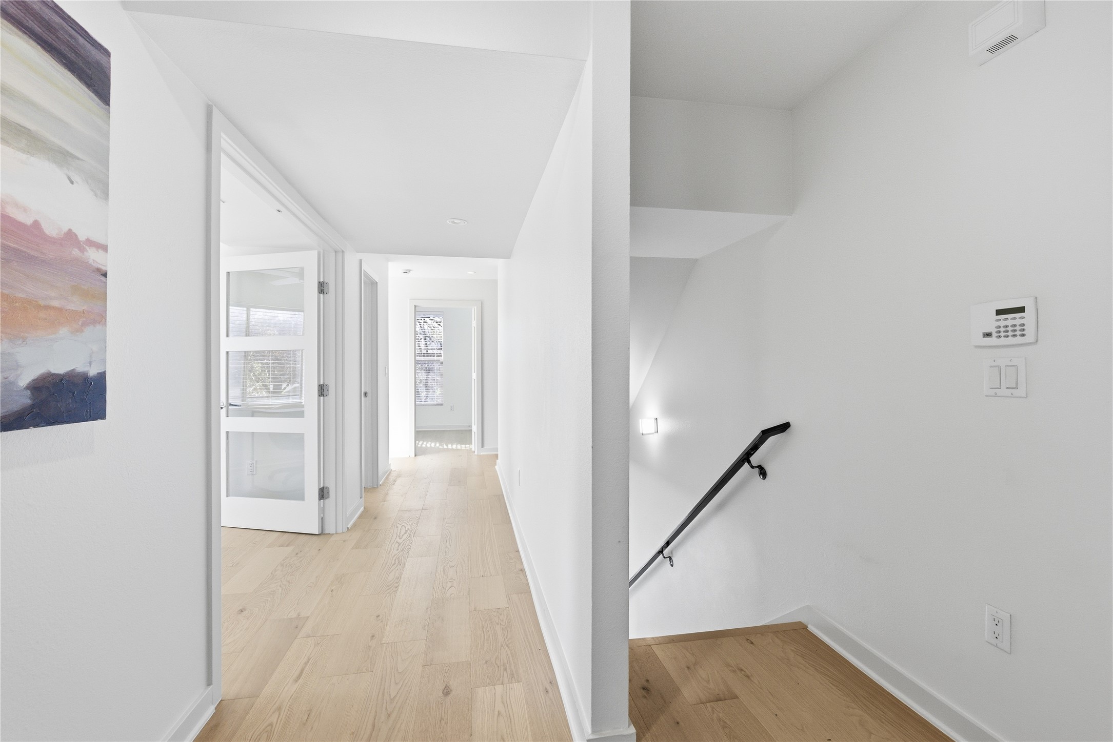 701 Zennia Street, Unit B Austin, TX 78751 - Photo 26 of 40 Corridor featuring an upstairs landing and light wood-style floors