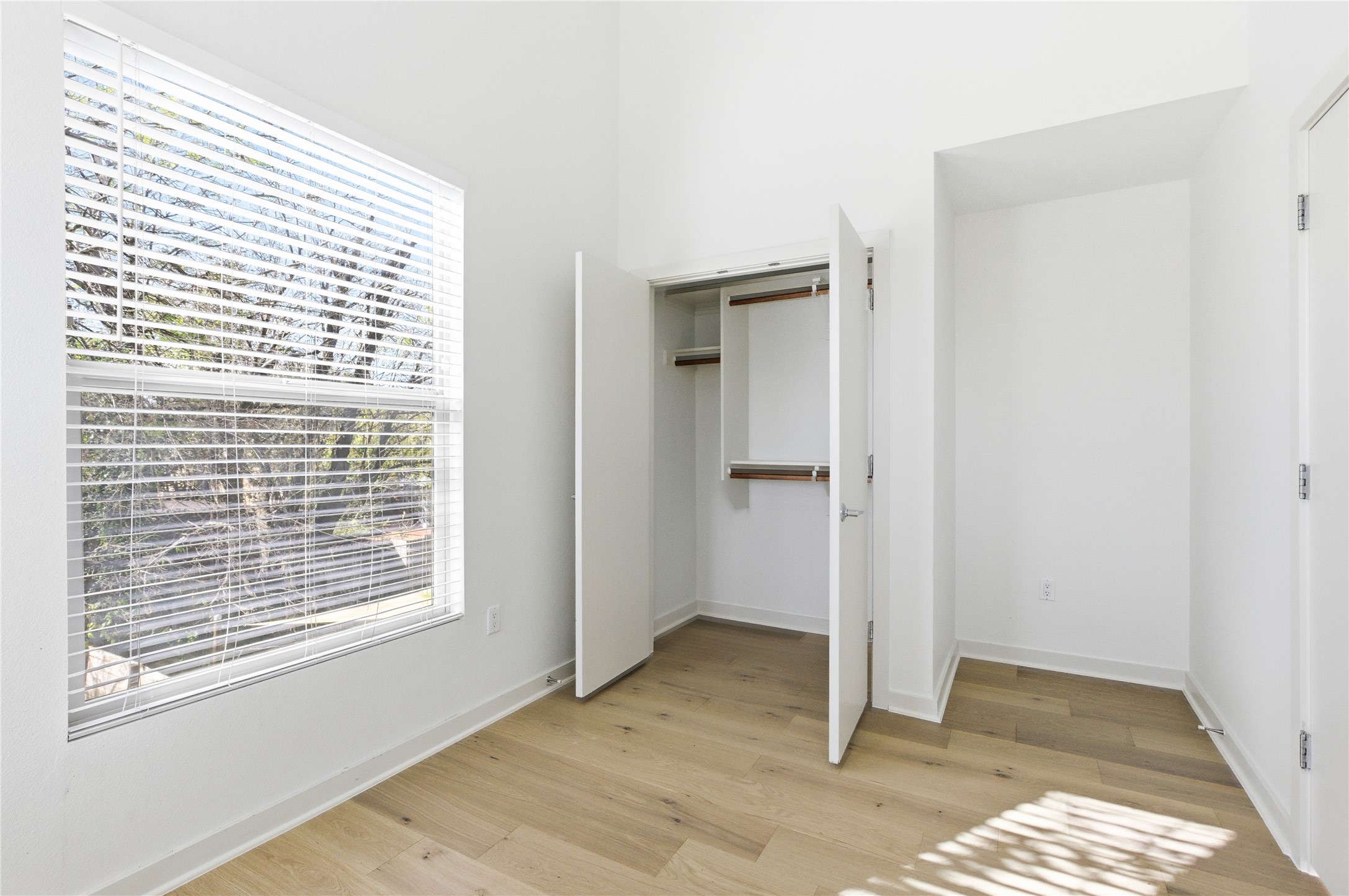 701 Zennia Street, Unit B Austin, TX 78751 - Photo 33 of 40 Unfurnished bedroom with a closet and light wood-style floors
