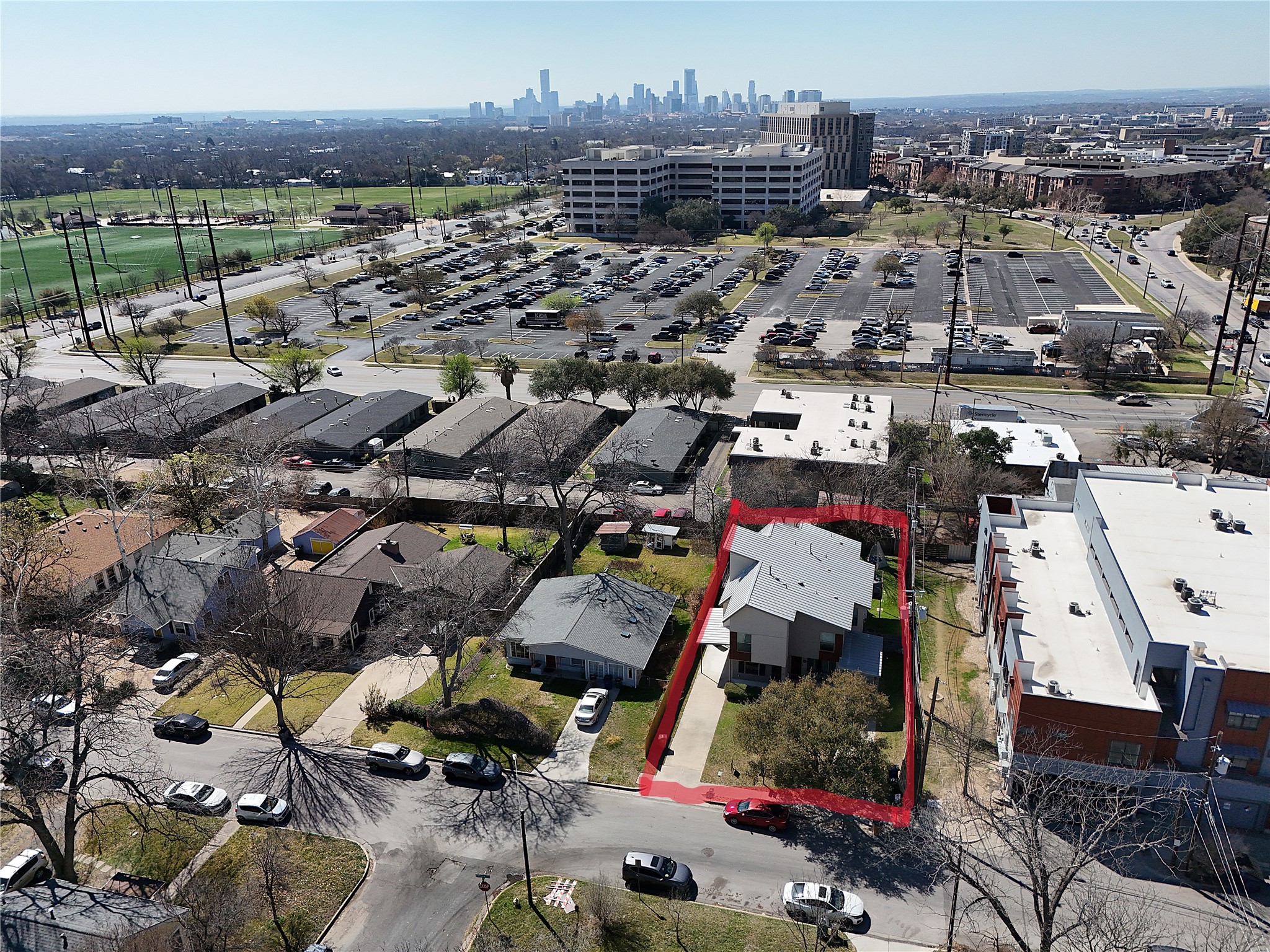 701 Zennia Street, Unit B Austin, TX 78751 - Photo 39 of 40 Aerial overview of property's location with property boundaries highlighted and city skyline