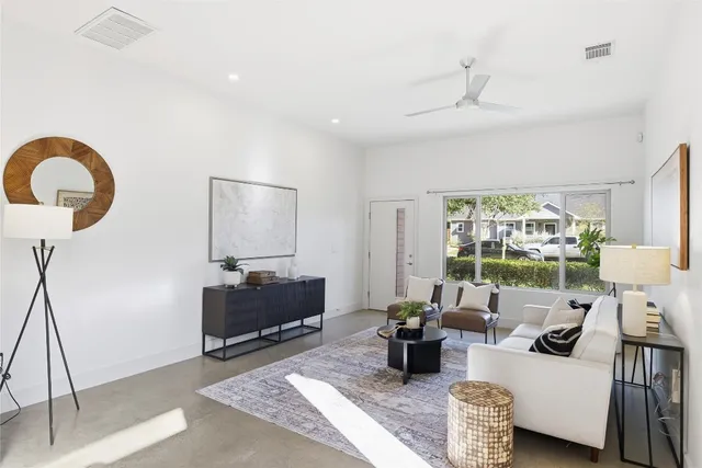 a living room with furniture and a large window