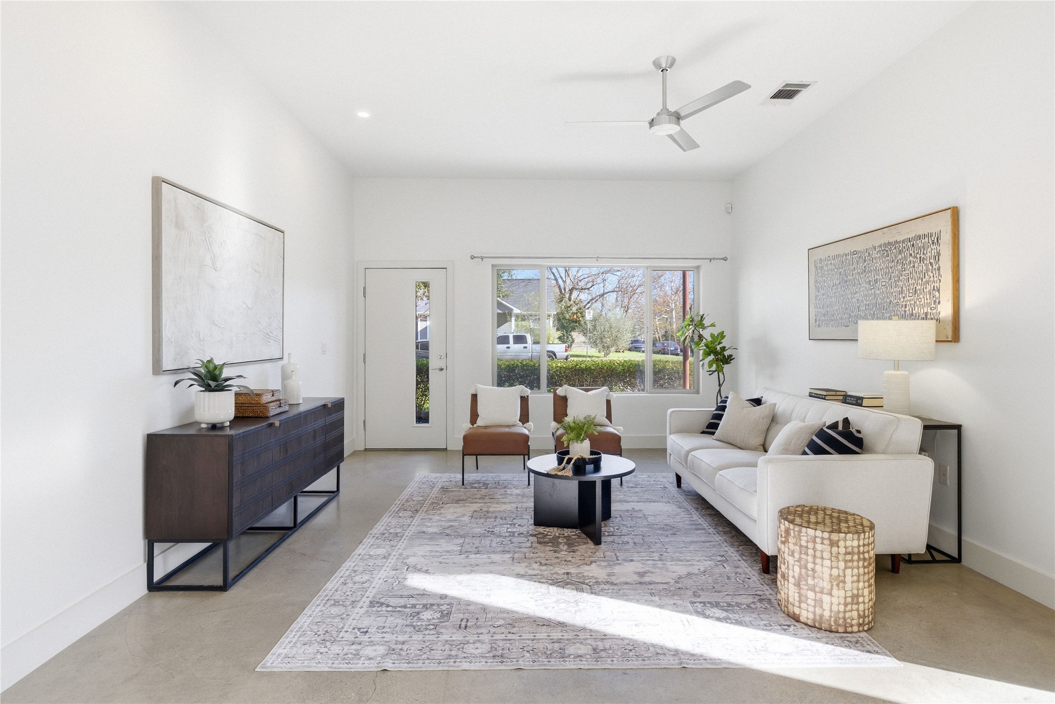 701 Zennia Street, Unit B Austin, TX 78751 - Photo 6 of 40 Living area featuring ceiling fan and finished concrete flooring