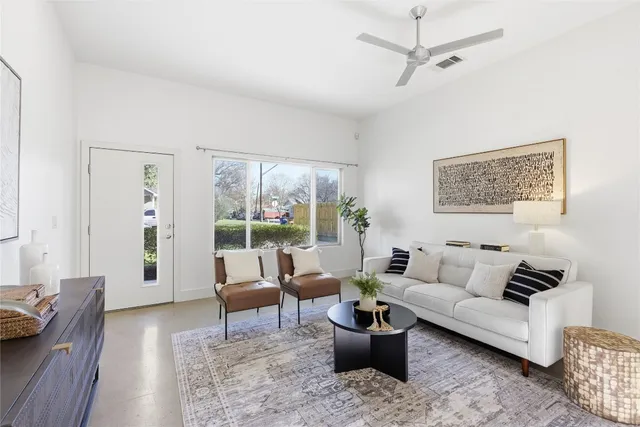 a living room with furniture and a potted plant