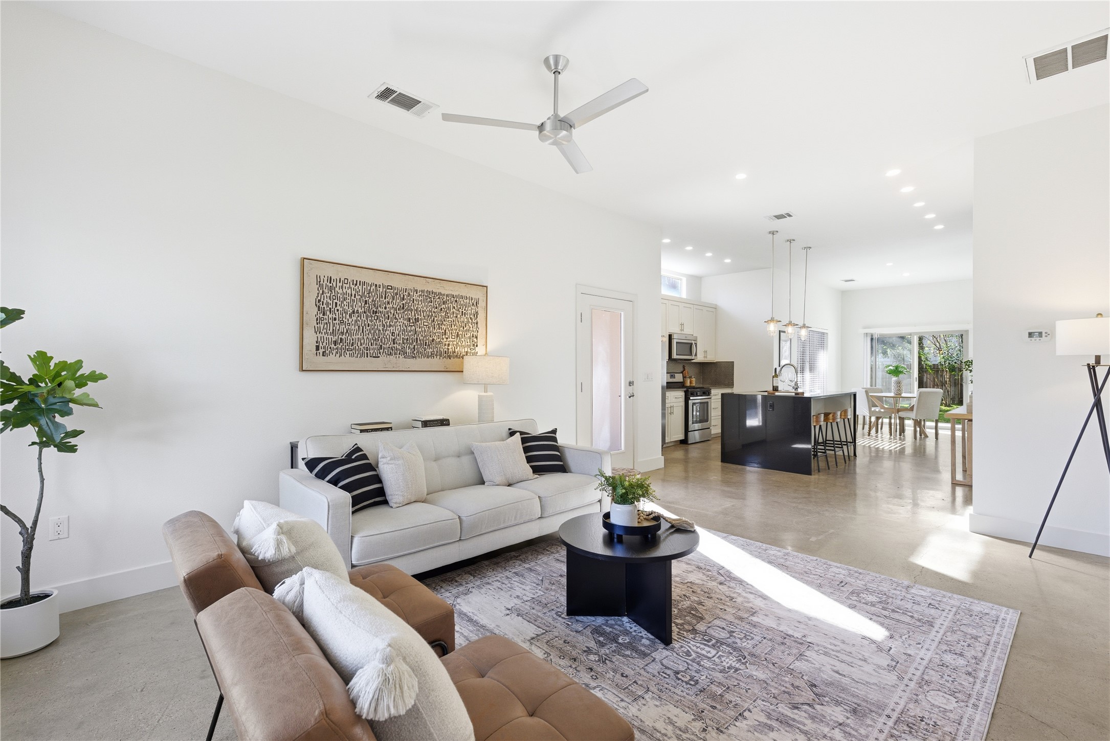 701 Zennia Street, Unit B Austin, TX 78751 - Photo 9 of 40 Living room with a ceiling fan, recessed lighting, and finished concrete flooring