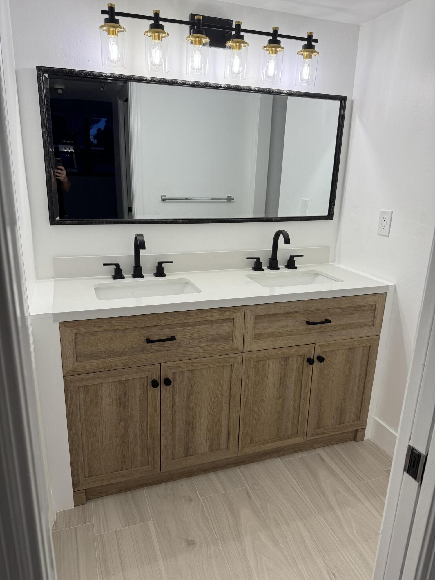 859 Jeffery Street, Unit 312 Boca Raton, FL 33487 - Photo 19 of 53 a bathroom with a sink vanity and mirror
