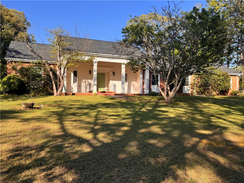2211 East River Street Anderson, SC 29621 - Photo 2 of 40 This residence features a classic exterior with a charming front porch, offering delightful curb appeal.