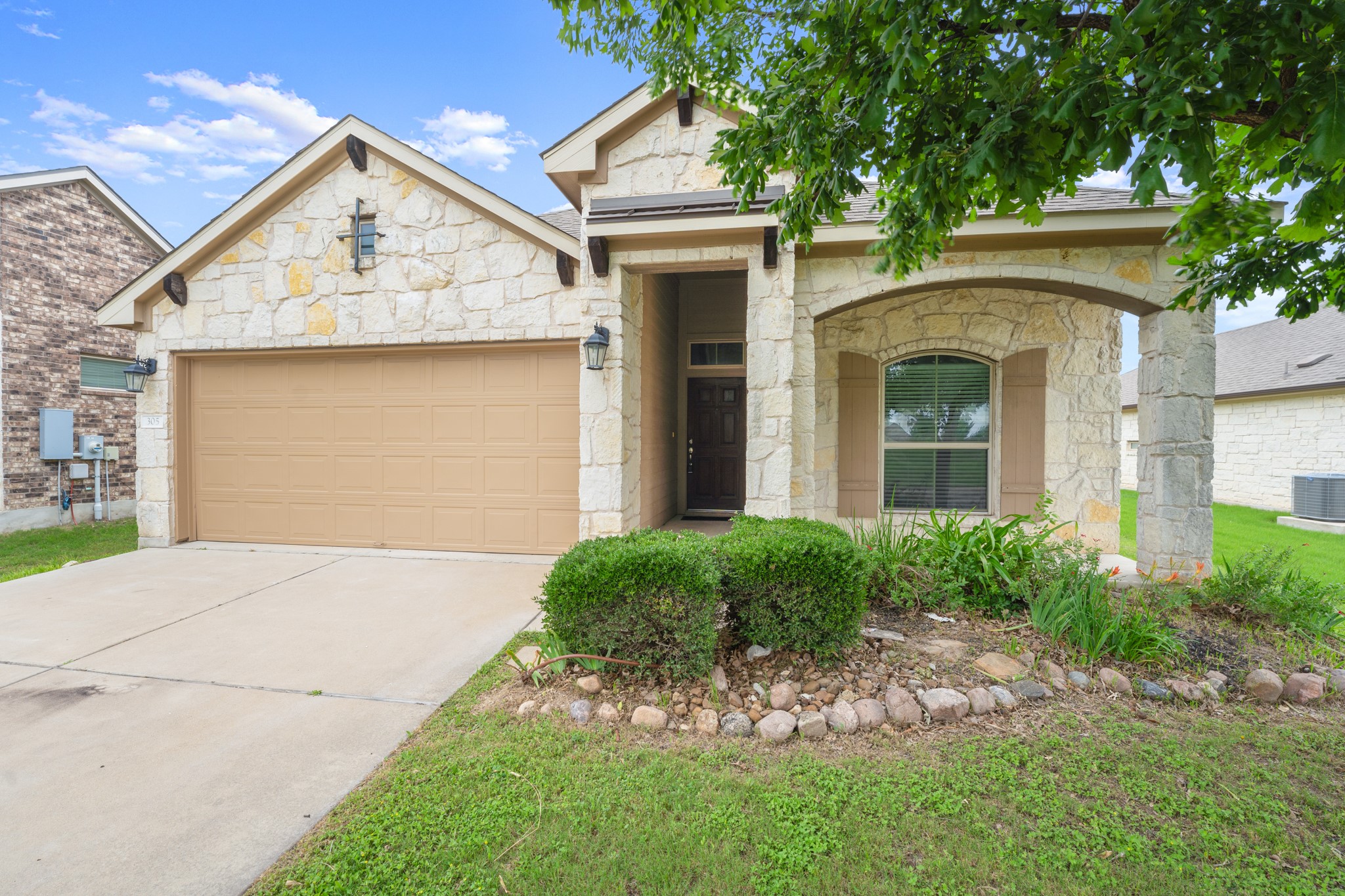 305 Longhorn Cavern Road Leander, TX 78641 - Photo 19 of 21 Check out that beautiful masonry work. The arched entryway and mature trees give this home such a warm, established feel.