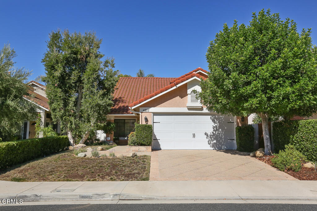 4211 Lost Springs Drive Calabasas, CA 91301 - Photo 1 of 40 a view of a white house with a yard and plants
