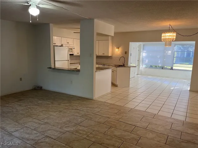 a view of a kitchen with furniture and chandelier