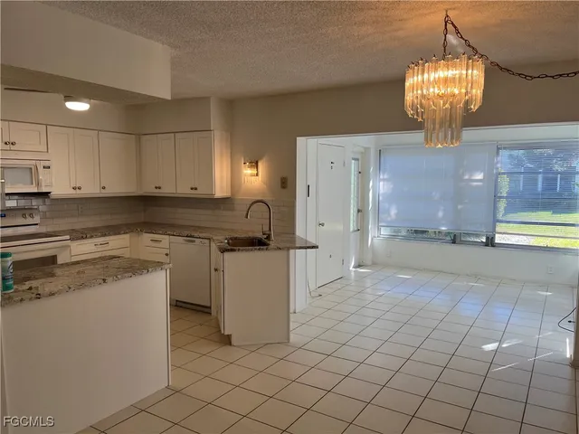 a kitchen with cabinets and window