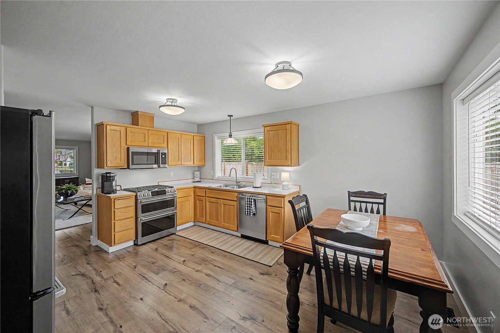 20919 Ronning Road Arlington, WA 98223 - Photo 9 of 28 a kitchen with stainless steel appliances kitchen island granite countertop a stove a sink a refrigerator dining table and chairs