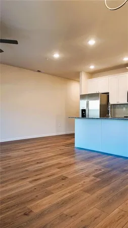 a view of a room with wooden floor
