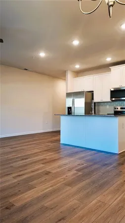 a view of a kitchen with microwave and cabinets