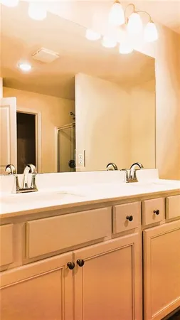a view of a kitchen with kitchen island and sink