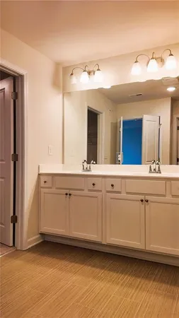 a bathroom with a double vanity sink and a mirror
