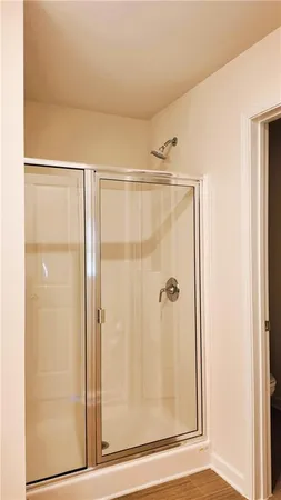 a bathroom with a glass shower door