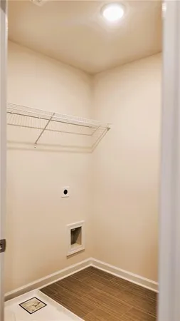 a view of a room with wooden floor