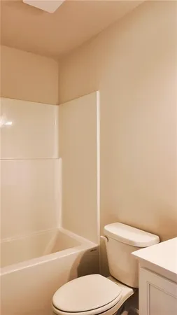 a white toilet and tub next to a shower