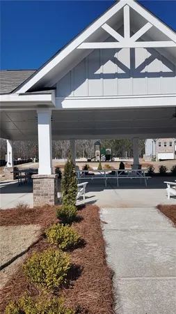 a living room with a couch and potted plants