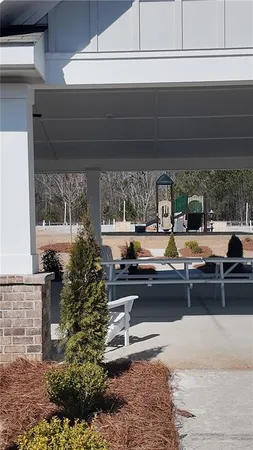 a living room with fireplace furniture and a floor to ceiling window