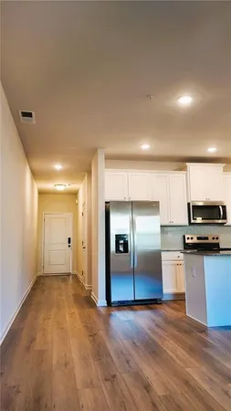 a view of a kitchen with a sink and a refrigerator