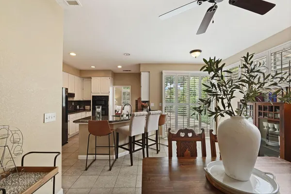 a dining room with furniture and wooden floor