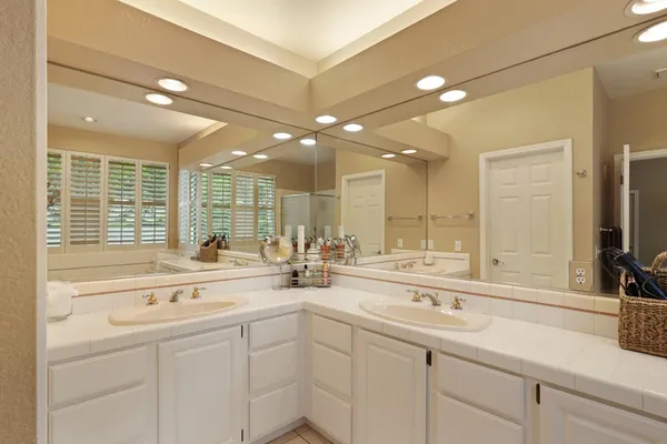 a large bathroom with a sink and a large mirror