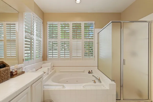 a bathroom with a tub sink and window