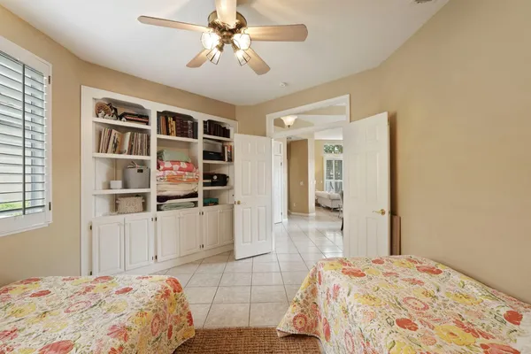 a bedroom with a large bed and a chandelier
