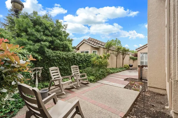 a view of a patio with table and chairs and potted plants