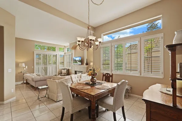 a view of a dining room with furniture large windows and wooden floor