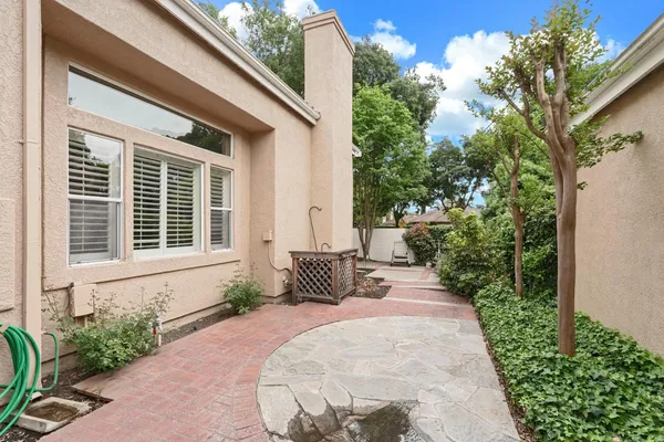 a view of house with backyard and sitting area
