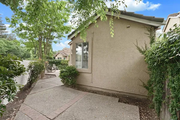 a side view of a house with a yard